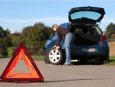 Woman with car trouble on road