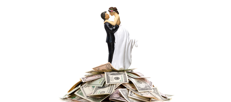 Bride and Groom figurine on top of money pile