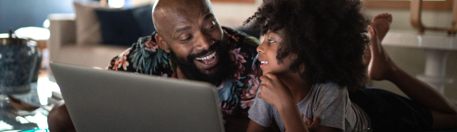 father and daughter working on computer