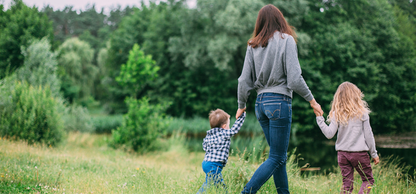 Mother with children walking in field
