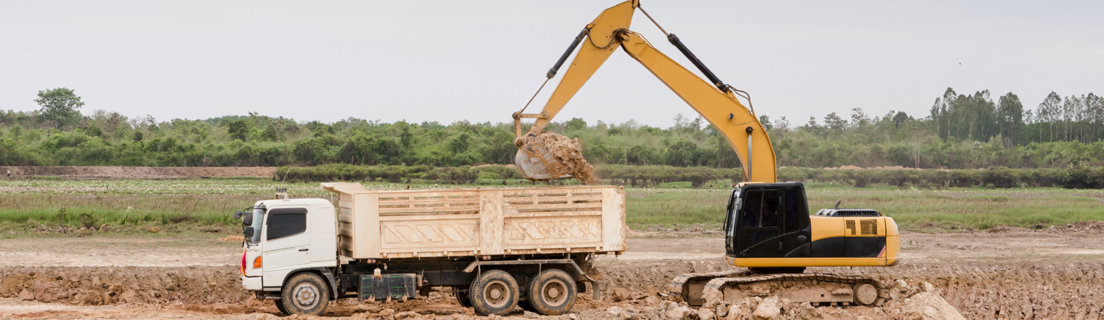 Dump truck and Track hoe on work site