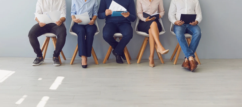Five people seated waiting