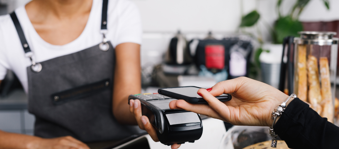 Person paying with their phone at a coffee shop